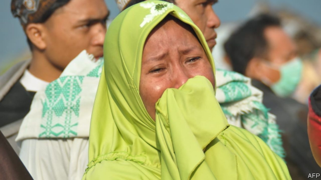 A tsunami strikes a poor part of Indonesia